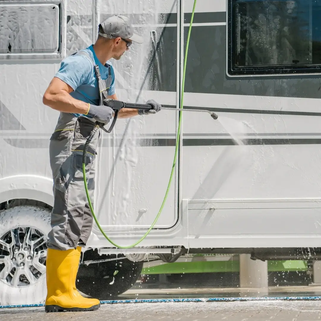 Man cleaning the exterior of an RV