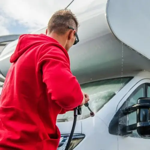 Man washing RV windshield